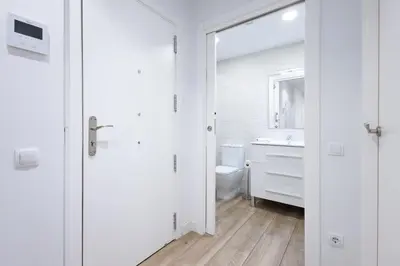 a white bathroom with a sink and a toilet at Stay U-nique Apartments Fabra i Puig in Barcelona