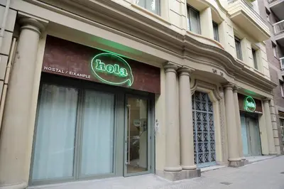 a halo sign on the side of a building at Hola Hostal Eixample in Barcelona