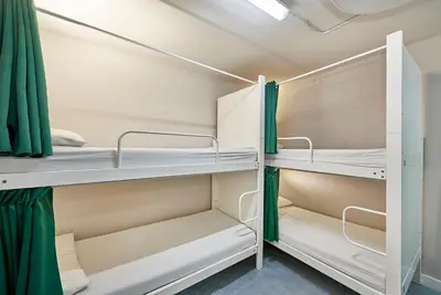 a room with bunk beds in a dorm room at Hola Hostal Eixample in Barcelona