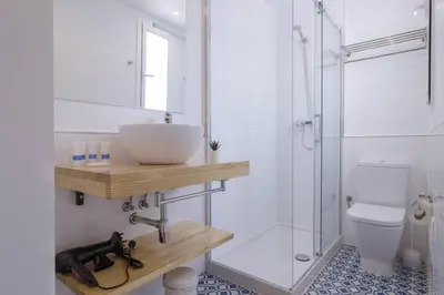 a bathroom with a sink and a shower at Ola Living Camp Nou in Hospitalet de Llobregat