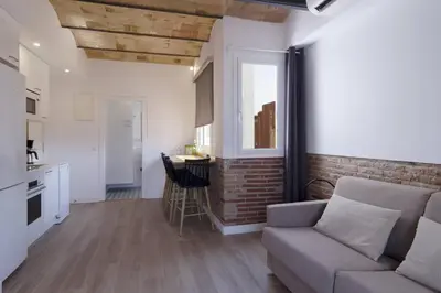 a white kitchen with a sink and a microwave at Ola Living Camp Nou in Hospitalet de Llobregat