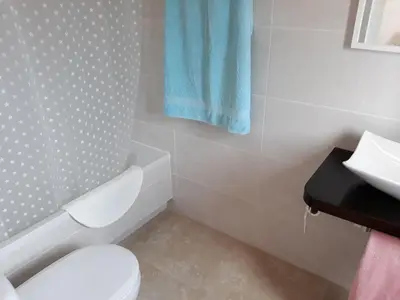 a bathroom with a white toilet and a sink at Mas Cabrit in Les Franqueses del Vallès