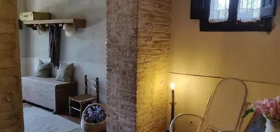 a room with two chairs and a brick wall at Mas Cabrit in Les Franqueses del Vallès