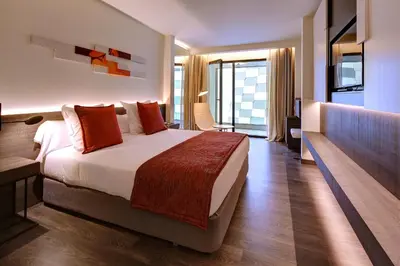 a hotel room with a large bed and a balcony at Olivia Balmes Hotel in Barcelona