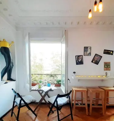 a dining room with a table and chairs and a window at Wow Hostel Barcelona in Barcelona