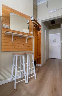 a kitchen with a counter and stools in a room at Wow Hostel Barcelona in Barcelona