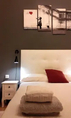 a bedroom with a bed with three pictures on the wall at Wow Hostel Barcelona in Barcelona