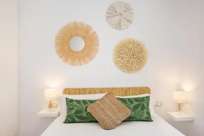 a bedroom with a bed with two lamps and a mirror at Stay U-nique Apartments Girona in Barcelona