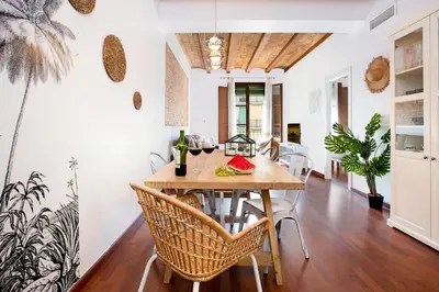 a dining room with a wooden table and chairs at Stay U-nique Apartments Girona in Barcelona