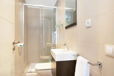 a bathroom with a sink and a toilet and a shower at Stay U-nique Apartments Girona in Barcelona