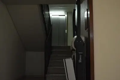 a hallway with stairs leading to a door with a treadmill at Vallparadis apartment in Terrassa