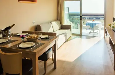 a living room with a table and a couch at Apartaments Maritim in Castelldefels