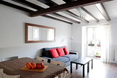 a living room with a blue couch and a table at My Address in Barcelona Old Town in Barcelona