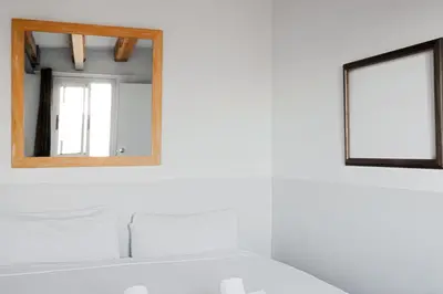 a bathroom with a mirror and a sink at My Address in Barcelona Old Town in Barcelona
