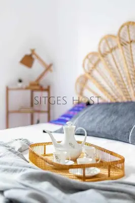 a tray with a tea set on a bed at Con patio y a 5 minutos de la playa in Sitges