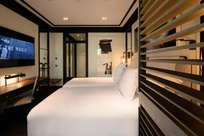 a bedroom with a couch and a bed and a tv at Seventy Barcelona in Barcelona