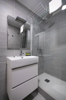 a white bathroom with a sink and a shower at White Sea by Seasidehomes in Castelldefels