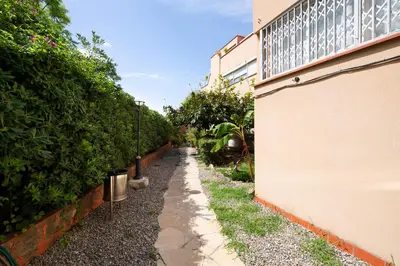 a sidewalk next to a building with a fence at White Sea by Seasidehomes in Castelldefels