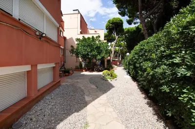 a walkway next to a building next to a building at White Sea by Seasidehomes in Castelldefels