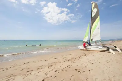 a boat on the beach with a person standing next to it at White Sea by Seasidehomes in Castelldefels