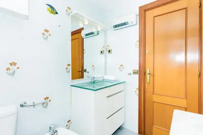 a bathroom with a sink and a mirror at HomeHolidaysRentals Keyla in Pineda de Mar