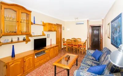 a living room with a couch and a tv at HomeHolidaysRentals Keyla in Pineda de Mar