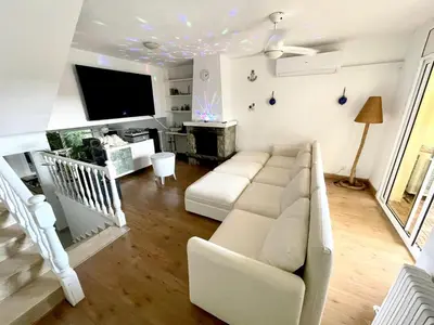 a living room with a couch and a tv at casa en Masnou junto a playa y tren in Masnou