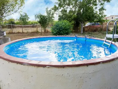 a large swimming pool with a swing in a yard at Mansion in St Martí with Vineyards & Garden in San Martín Sarroca