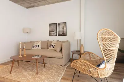 a living room with a couch and a chair at En Casa de Calders 5 in Barcelona