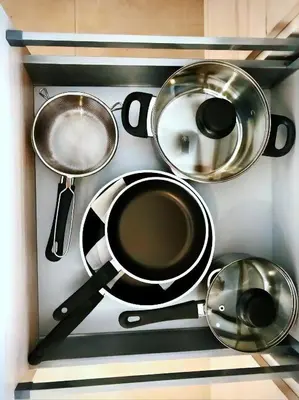 a bunch of pots and pans on a shelf at Mon Residence Sant Jeroni in Manresa