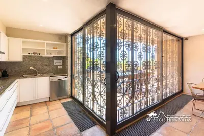 an outdoor patio with a table and chairs at VILLA DUMAS with amazing sea views, AC and private pool in Sitges