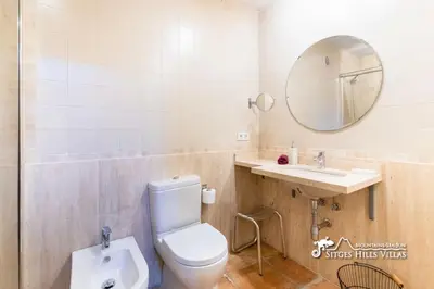 a bathroom with a shower and a toilet and a sink at VILLA DUMAS with amazing sea views, AC and private pool in Sitges