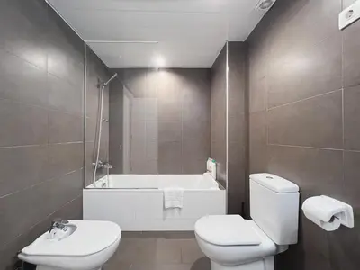 a bathroom with a toilet and a bath tub at Stay U-nique Apartments Pellaires in Barcelona