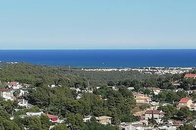 an aerial view of a city and the ocean at MAS DEL VENT- Barbacoa, jardín, piscina privada y vistas a mar in Cunit