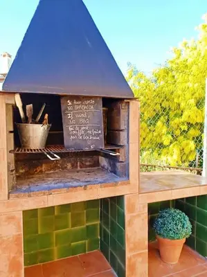 a model of a pizza oven on a patio at MAS DEL VENT- Barbacoa, jardín, piscina privada y vistas a mar in Cunit