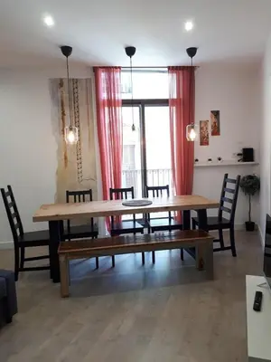 a dining room with a wooden table and chairs at Beautiful Apartment on Las Ramblas with Port views in Barcelona