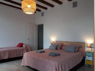 a bedroom with two beds and a chandelier at Beautiful Apartment on Las Ramblas with Port views in Barcelona