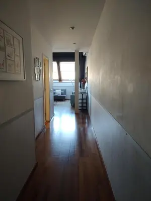 a hallway of a living room with a wooden floor at Passeig De Gràcia Luxury in Barcelona
