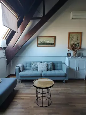 a living room with a blue couch and a table at Passeig De Gràcia Luxury in Barcelona