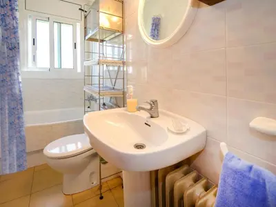 a bathroom with a sink and a toilet and a mirror at Holiday Home Envalira by Interhome in Cunit