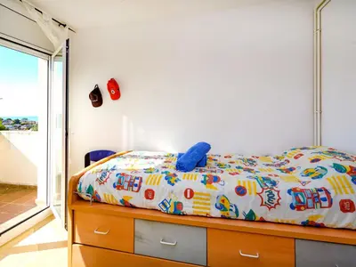 a bedroom with a bed with a colorful comforter at Holiday Home Envalira by Interhome in Cunit