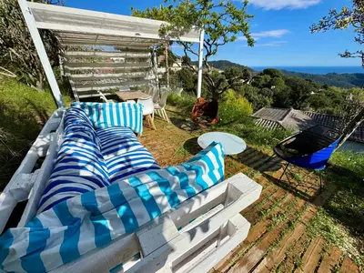 a group of blue and white couches in a yard at CASA PARAÍSO PISCINA TRANQUILIDAD in Sant Cebrià de Vallalta