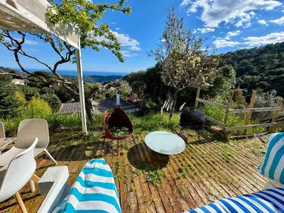 a patio with a table and chairs and a fence at CASA PARAÍSO PISCINA TRANQUILIDAD in Sant Cebrià de Vallalta