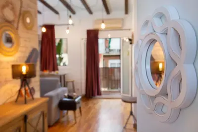 a living room with a mirror on the wall at Stay U-nique Apartments Ramón y Cajal in Barcelona