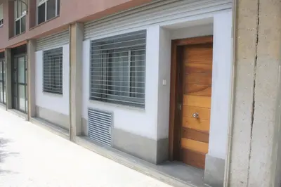 a building with a wooden door on a street at Alguera Hola Apartments in Barcelona