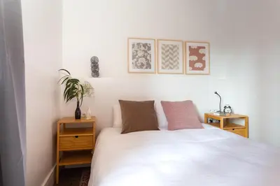 a bedroom with a white bed with two night stands at Casa Cosi - Sant Gervasi 1 in Barcelona