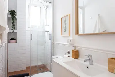 a white bathroom with a sink and a shower at Casa Cosi - Sant Gervasi 1 in Barcelona