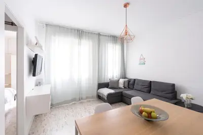 a living room with a couch and a table at Nordic apartment Sagrada Familia in Barcelona