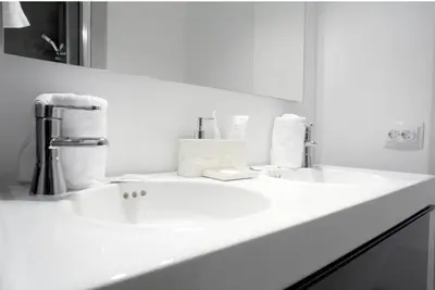 a white bathroom with two sinks and a mirror at Nordic apartment Sagrada Familia in Barcelona