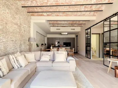 a living room with a white couch and a brick wall at Poble Nou I You Stylish Apartments in Barcelona